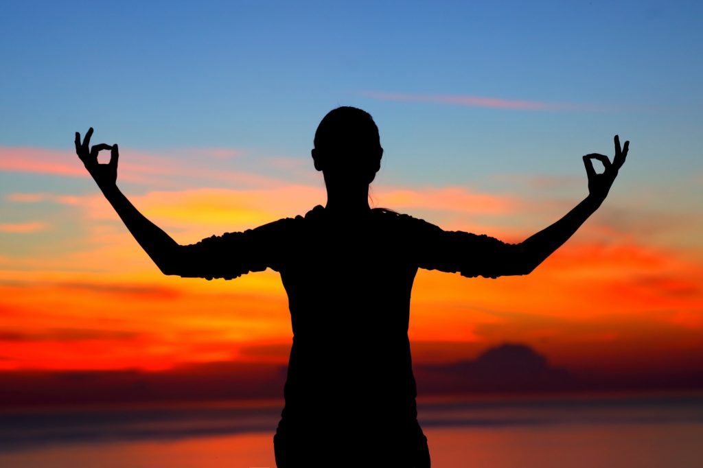 Woman meditating outdoors